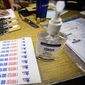 Hand sanitizer and stickers are set up at the Lincoln Lodge Polling Station, 1st ward, Tuesday, March 17th, 2020 in Chicago. (James Foster/Chicago Sun-Times via AP) ** FILE **