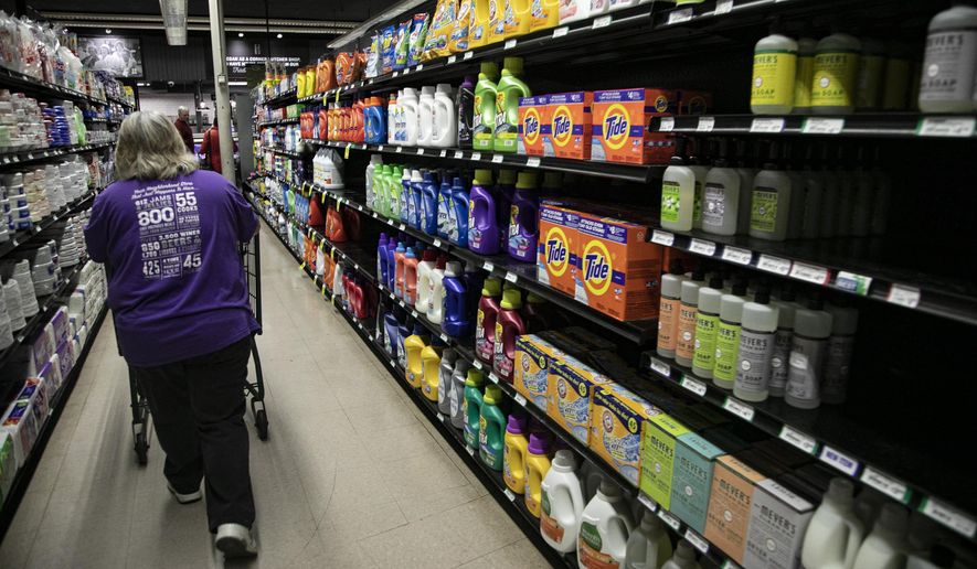 Diane Strauss, 55, of Warren fills grocery orders at Holiday Market in Royal Oak Tuesday, March, 17, 2020. Online grocery orders at the store have seen an uptick since the Coronavirus threat. (Mandi Wright/Detroit Free Press via AP)