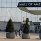 Shoppers, visitors and employees leave the Mall of America Tuesday, March 17, 2020 as the mall in Bloomington, Minn. moments before it closed temporarily through at least March 31 in an effort to limit the spread of the coronavirus. (AP Photo/Jim Mone)