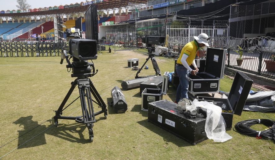 A staff of broadcast packs up equipment as The Pakistan Super League has been postponed, at Gaddafi Stadium in Lahore, Pakistan, Tuesday, March 17, 2020. The PSL has been postponed amid the coronavirus pandemic. The Pakistan Cricket Board said the Twenty20 tournament has been "postponed, to be rescheduled." For most people, the new coronavirus causes only mild or moderate symptoms. For some it can cause more severe illness. (AP Photo/K.M. Chaudhry)