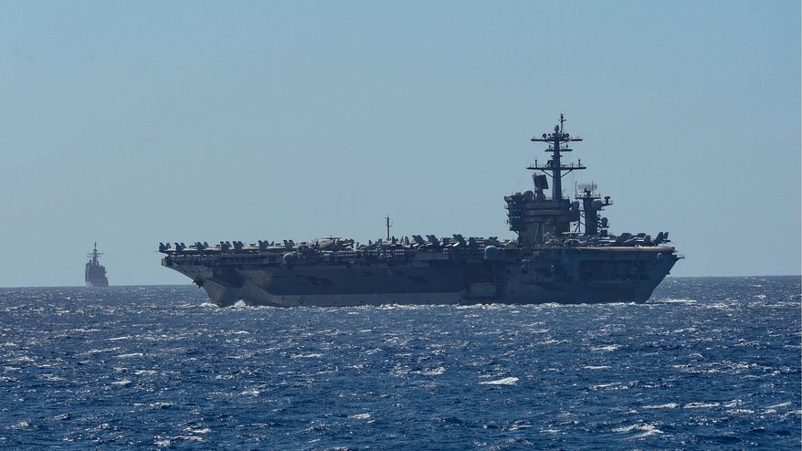 The aircraft carrier USS Theodore Roosevelt and the Ticonderoga-class guided-missile cruiser USS Bunker Hill are among warships at risk of electromagnetic attacks while transiting the South China Sea. (U.S. Navy) ** FILE **