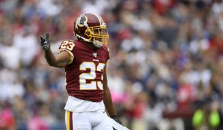 Washington Redskins cornerback Quinton Dunbar (23) gestures during the first half of an NFL football game against the New England Patriots, Sunday, Oct. 6, 2019, in Washington. (AP Photo/Nick Wass) ** FILE **