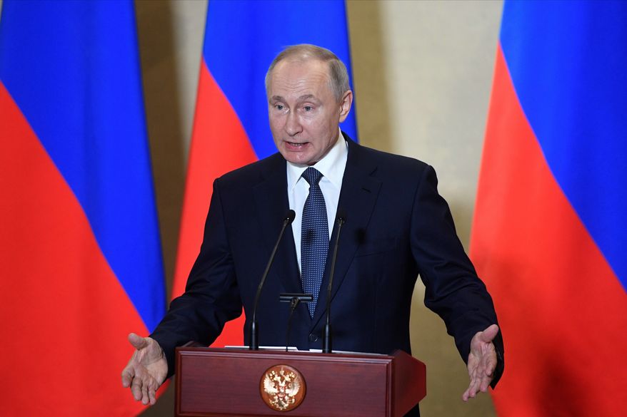 Russian President Vladimir Putin gestures while speaking during an awards ceremony for those who led the construction of the 19 kilometers (12 miles) road and rail Crimean Bridge which is intended to facilitate links with Crimea, which Russia annexed from Ukraine in 2014. in Sevastopol, Crimea, Wednesday, March 18, 2020. Putin traveled to Crimea on a trip marking the anniversary of its annexation from Ukraine in 2014. (Alexander Nemenov, Pool via AP)