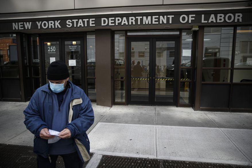 Visitors to the Department of Labor are turned away at the door by personnel due to closures over coronavirus concerns, Wednesday, March 18, 2020, in New York. Applications for jobless benefits are surging in some states as coronavirus concerns shake the U.S. economy. The sharp increase comes as governments have ordered millions of workers, students and shoppers to stay home as a precaution against spreading the virus that causes the COVID-19 disease. (AP Photo/John Minchillo)