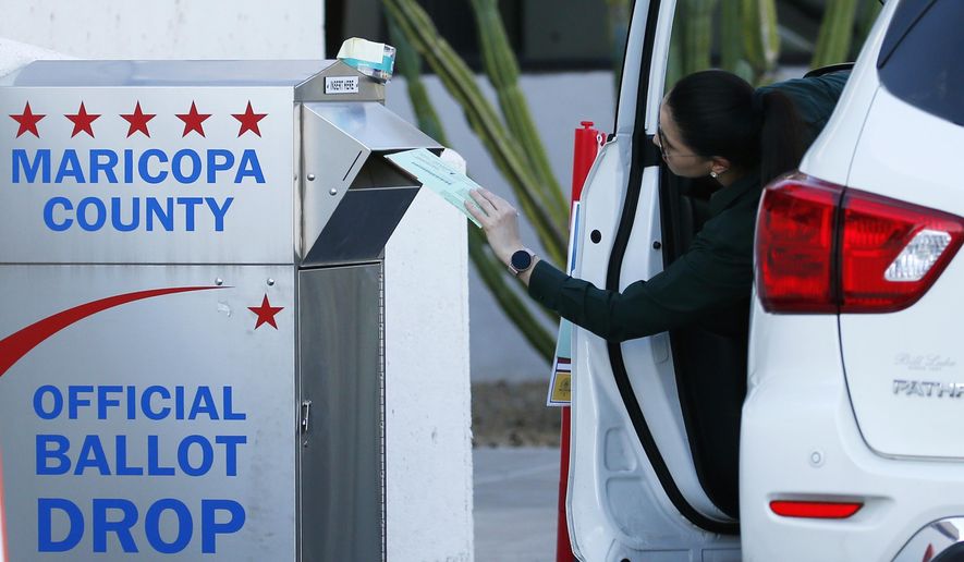 A voter drops off a ballot for the Arizona Democratic presidential preference election Tuesday, March 17, 2020, in Phoenix. (AP Photo/Ross D. Franklin)