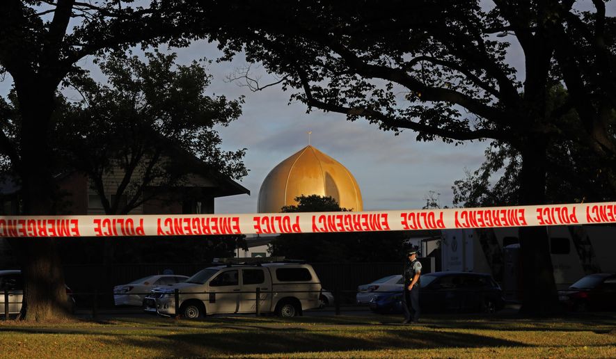 FILE - In this March 17, 2019 file photo, a police officer stands guard in front of the Masjid Al Noor mosque in Christchurch, New Zealand, where one of two mass shootings occurred. According to a report released Wednesday, March 18, 2020, by an organization that tracks far-right extremists, a recent surge in white nationalism in the U.S. has led to a growing threat of violence by factions that embrace bloodshed and advocate for a race war. The man accused of attacking two mosques in Christchurch, New Zealand, and killing 51 people in March 2019 devoted a section of his manifesto to the concept of accelerationism, a fringe philosophy that promotes mass violence to fuel society’s collapse. (AP Photo/Vincent Yu, File)
