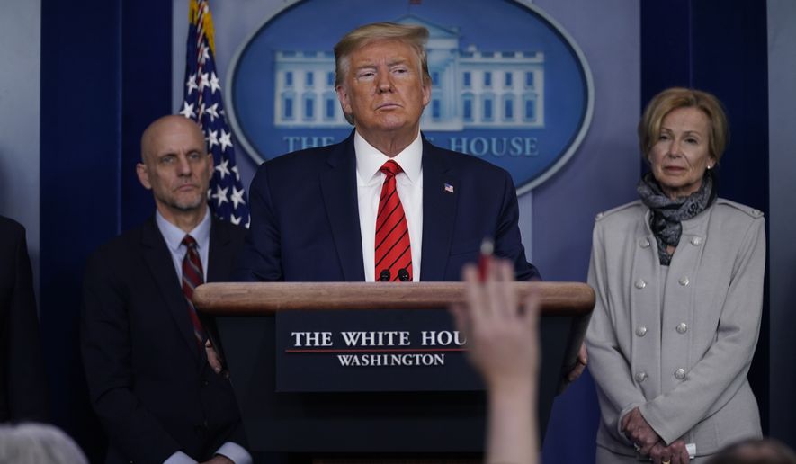 President Donald Trump takes questions during press briefing with the coronavirus task force, at the White House, Thursday, March 19, 2020, in Washington. Food and Drug Administration Commissioner Dr. Stephen Hahn, at left, and Dr. Deborah Birx, White House coronavirus response coordinator, at right listen. (AP Photo/Evan Vucci)