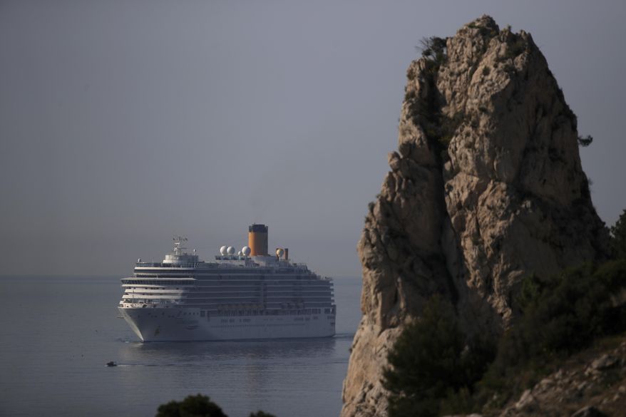 The trans-Atlantic cruise ship Costa Luminosa arrives in the port of Marseille, southern France, Thursday, March 19, 2020. The ship was allowed to stop in Tenerife in Spain on Sunday and offload three people who needed to be evacuated. For most people, the new coronavirus causes only mild or moderate symptoms. For some it can cause more severe illness. (AP Photo/Daniel Cole)