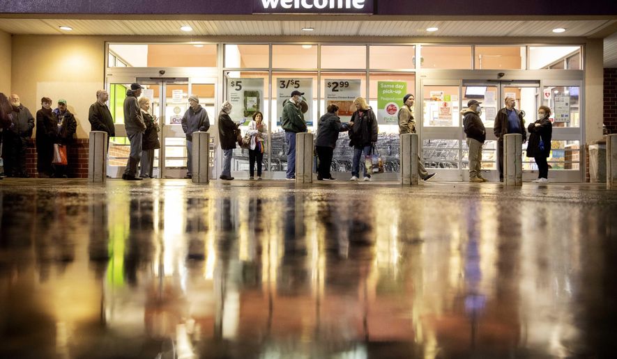 Shoppers wait in line to enter a Stop & Shop supermarket during hours open daily only for seniors Thursday, March 19, 2020, in North Providence, R.I. This week grocery store chains and other retailers began offering special shopping hours for seniors and other groups considered the most vulnerable to the new coronavirus. The dedicated shopping times are designed to allow seniors, pregnant women and people with underlying health conditions to shop among smaller crowds and reduce their chances of acquiring the virus. (AP Photo/David Goldman)