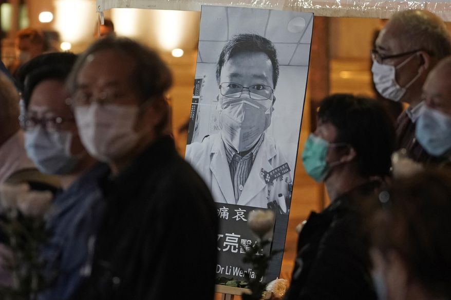 In this Feb. 7, 2020, file photo, people wearing masks attend a vigil for Chinese doctor Li Wenliang, who was reprimanded for warning about the outbreak of the new coronavirus, in Hong Kong. China has taken the highly unusual move of exonerating the doctor who was reprimanded for warning about the coronavirus outbreak and later died of the disease. An official media report said police in Wuhan had revoked its admonishment of Dr. Li that had included a threat of arrest and issued a “solemn apology&amp;quot; to his family. (AP Photo/Kin Cheung, File)