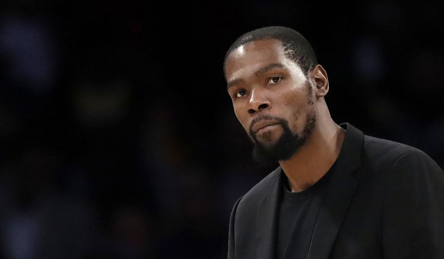 In this March 10, 2020, file photo, Brooklyn Nets&#x27; Kevin Durant watches during the second half of the team&#x27;s NBA basketball game against the Los Angeles Lakers in Los Angeles.  (AP Photo/Marcio Jose Sanchez, file) ** FILE **