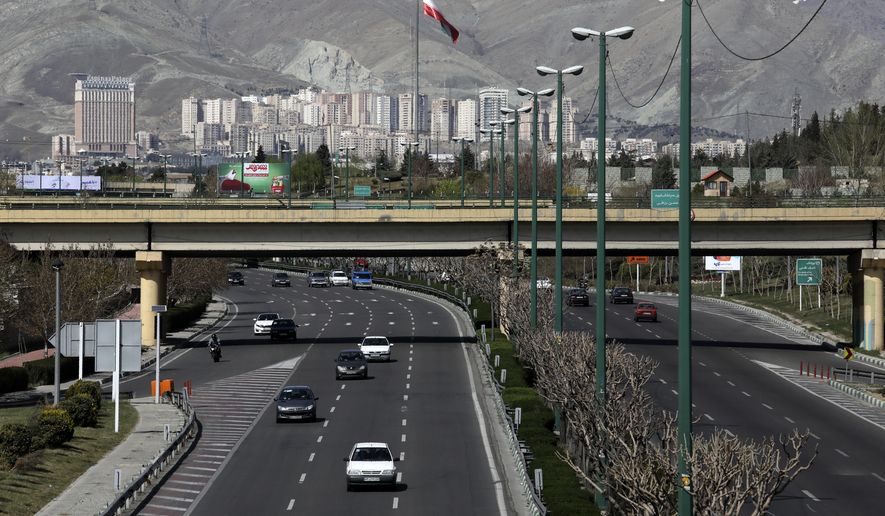 Cars drive in a highway in northern Tehran, Iran, Friday, March 20, 2020, on the first day of Iranian New Year, called Nowruz, or "New Day" in Farsi, the Persian holiday marking the the spring equinox. The new coronavirus has cut into the ancient Nowruz and has further slowed the Islamic Republic's economy. (AP Photo/Vahid Salemi)