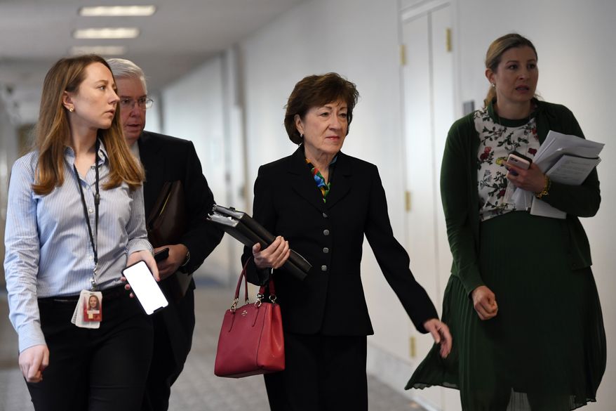 Sen. Susan Collins, R-Maine, arrives for a meeting on Capitol Hill in Washington, Friday, March 20, 2020, to work on an economic package to deal with the coronavirus. (AP Photo/Susan Walsh)