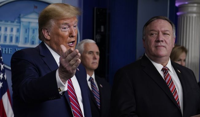 Secretary of State Mike Pompeo listens as President Donald Trump speaks during a coronavirus task force briefing at the White House, Friday, March 20, 2020, in Washington. (AP Photo/Evan Vucci)