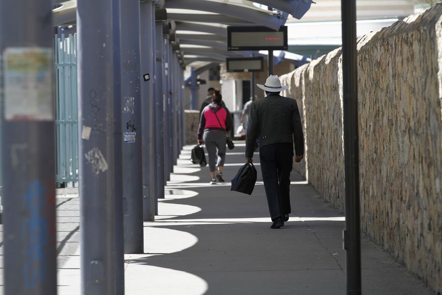 Travelers walk toward Ciudad Juarez, Mexico on Friday, March 20, 2020, a a border crossing in El Paso, Texas. Residents of both cities cross daily for family visits and to purchase basic good. Cigarettes and medications are cheaper on the Mexican side, electronics and alcohol are cheaper on the American side. President Donald Trump and Mexican Foreign Secretary Marcelo Ebrard said Friday the two governments will prohibit recreational and tourist travel starting at midnight, similar to the restrictions put in place earlier this week along the U.S. and Canadian border. (AP Photo/Cedar Attanasio)
