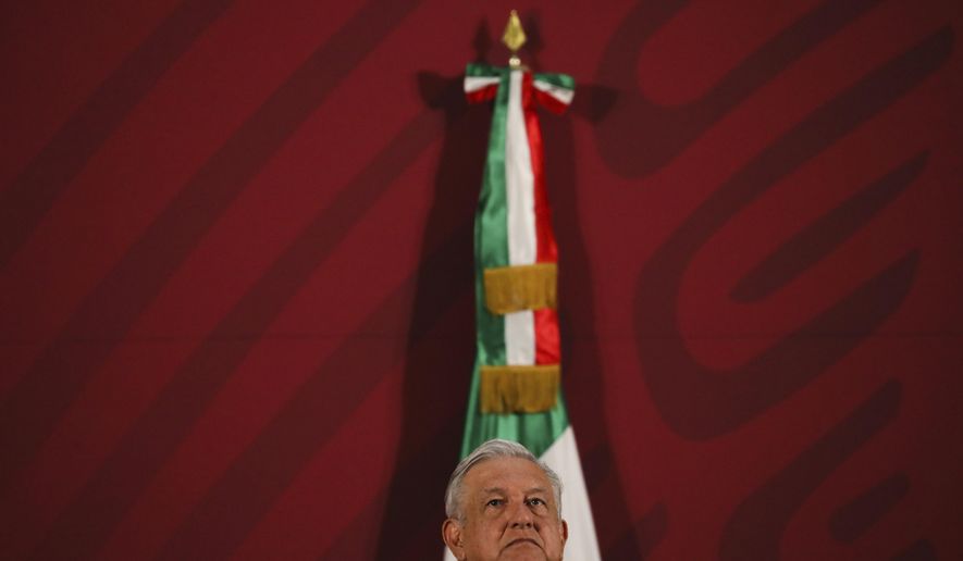 Mexico's President Andres Manuel Lopez Obrador gives his daily news conference at the presidential palace in Mexico City, early Thursday, March 19, 2020. (AP Photo/Fernando Llano)