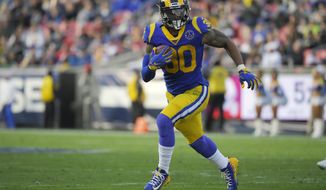 FILE - In this Dec. 29, 2019, file photo, Los Angeles Rams running back Todd Gurley runs a play during the first half of an NFL football game against the Arizona Cardinals, in Los Angeles. The Atlanta Falcons have agreed to a one-year deal with three-time Pro Bowl running back Todd Gurley, one day after he was cut by the Los Angeles Rams. A person familiar with the deal told The Associated Press about the agreement on Friday, March 20, 2020, on condition of anonymity because the deal will not be official until Gurley passes a physical. (AP Photo/Mark J. Terrill, File)