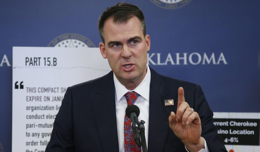 In this Dec. 17, 2019, file photo, Oklahoma Gov. Kevin Stitt gestures during a news conference in Oklahoma City. Seven national organizations representing patients with serious medical conditions have criticized Stitt for rolling out his Medicaid expansion plan during the coronavirus pandemic. (AP Photo/Sue Ogrocki, File)