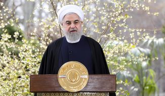 In this photo released on Friday, March 20, 2020, by the official website of the office of the Iranian Presidency, President Hassan Rouhani delivers a message for the Iranian New Year, or Nowruz, in Tehran, Iran. (Iranian Presidency Office via AP) FILE 