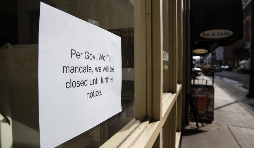 A sign is posted in the window of a closed business in Philadelphia, Friday, March 20, 2020. Pennsylvania Gov. Tom Wolf directed all "non-life-sustaining" businesses to close their physical locations late Thursday and said state government would begin to enforce the edict starting early Saturday. (AP Photo/Matt Rourke)