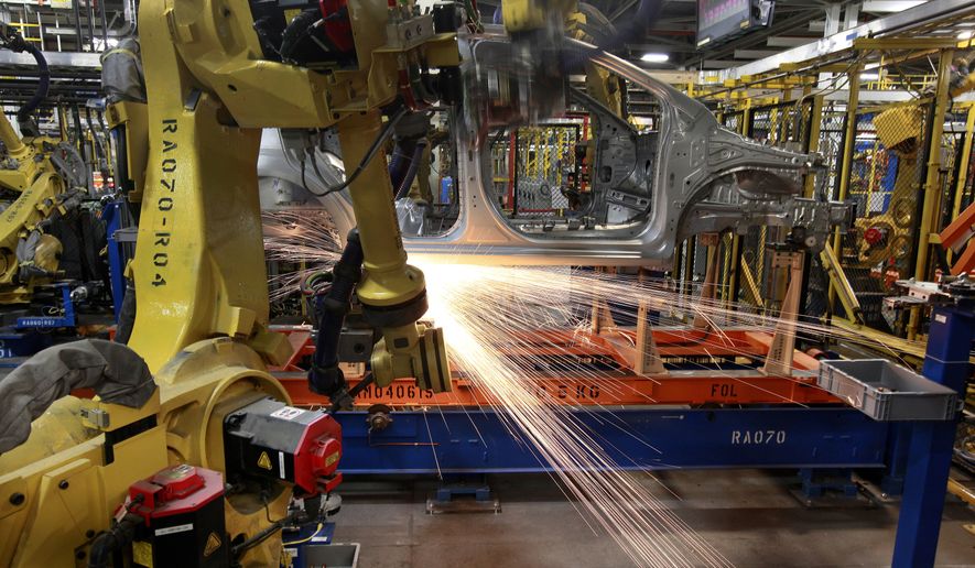 In this May 19, 2011 photo, robots weld a Chevrolet Sonic at the General Motors Orion Assembly plant in Orion Township, Mich. General Motors, Ford, jet engine maker Rolls-Royce and other companies are talking to their governments about repurposing idled factories to produce vital goods to fight the coronavirus such as ventilators and surgical masks. On Friday, March 20, 2020 President Donald Trump invoked the Korean War-era Defense Production Act, allowing the government to marshal the private sector to fight the COVID-19 pandemic. Although it allows the government to steer factories to overcome shortages, makers of heavy goods such as cars and trucks can't just flip a switch and produce something else. (AP Photo/Paul Sancya)