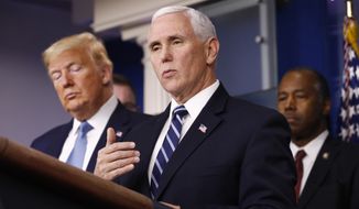 President Donald Trump listens as Vice President Mike Pence speaks during a coronavirus task force briefing at the White House, Saturday, March 21, 2020, in Washington. Housing and Urban Development Secretary Ben Carson is at right. (AP Photo/Patrick Semansky)