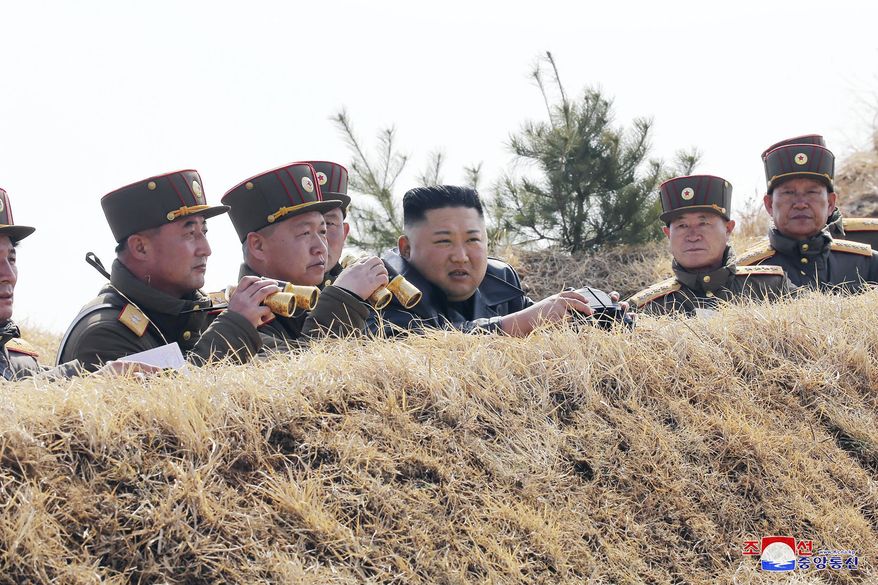 In this Friday, March 20, 2020, photo provided by the North Korean government, North Korean leader Kim Jong Un supervises an artillery firing competition between army units in the country's west in North Korea. Independent journalists were not given access to cover the event depicted in this image distributed by the North Korean government. The content of this image is as provided and cannot be independently verified. Korean language watermark on image as provided by source reads: "KCNA" which is the abbreviation for Korean Central News Agency. (Korean Central News Agency/Korea News Service via AP)