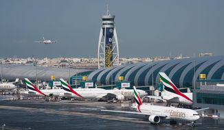CORRECTS TO SAY THAT EMIRATES HAS DRAMATICALLY CUT ITS PASSENGER FLIGHT DESTINATIONS AND NOT SUSPENDED ALL FLIGHTS. -- FILE - In this Dec. 11, 2019 file photo, an Emirates jetliner comes in for landing at Dubai International Airport in Dubai, United Arab Emirates. On Sunday, March 22, 2020, long-haul carrier Emirates it has dramatically cut its passenger flight destinations from 145 locations to just 13 countries. (AP Photo/Jon Gambrell, File)