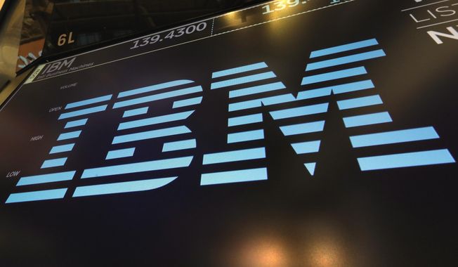 In this March 18, 2019, photo, the logo for IBM appears above a trading post on the floor of the New York Stock Exchange. (AP Photo/Richard Drew) ** FILE **