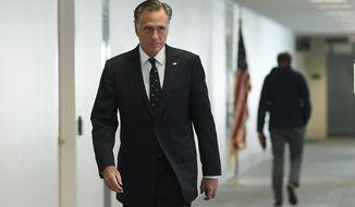 Sen. Mitt Romney, R-Utah, heads into a Republican policy lunch on Capitol Hill in Washington, Thursday, March 19, 2020. (AP Photo/Susan Walsh)