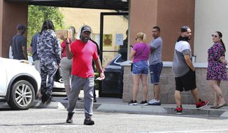 A gun owner leaves the Shoot Straight gun store in Casselberry, Fla., Sunday, March 22, 2020. Gun sales have increased nationwide in response to the coronavirus pandemic. (Joe Burbank/Orlando Sentinel via AP)