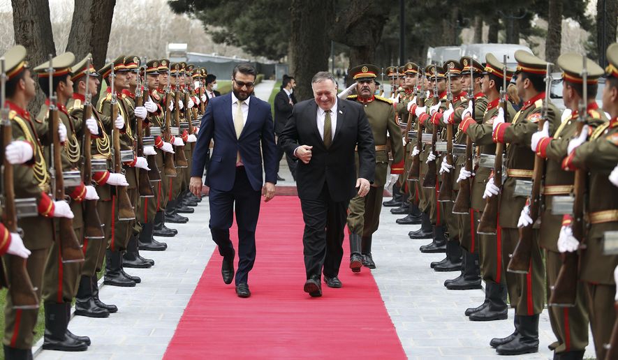 U.S. Secretary of State Mike Pompeo, right, and Afghanistan&#39;s National Security Adviser Hamdullah Mohib, arrives at the Presidential Palace in Kabul, Afghanistan, Monday, March 23, 2020. Pompeo was in Kabul on an urgent visit Monday to try to move forward a U.S. peace deal signed last month with the Taliban, a trip that comes despite the coronavirus pandemic, at a time when world leaders and statesmen are curtailing official travel. (Afghan Presidential Palace via AP)