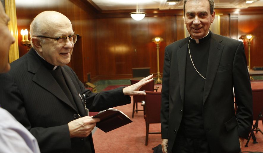 FILE – In this Friday, October 17, 2008 file photo, Pope Benedict XVI has appointed Rev. Dennis M. Schnurr, right the coadjutor archbishop of Cincinnati along with Archbishop Daniel Pilarczyk, left as announced during a press conference. Retired Archbishop Pilarczyk died on Sunday, March 22, 2020. (Jeff Swinger/The Cincinnati Enquirer via AP, File)