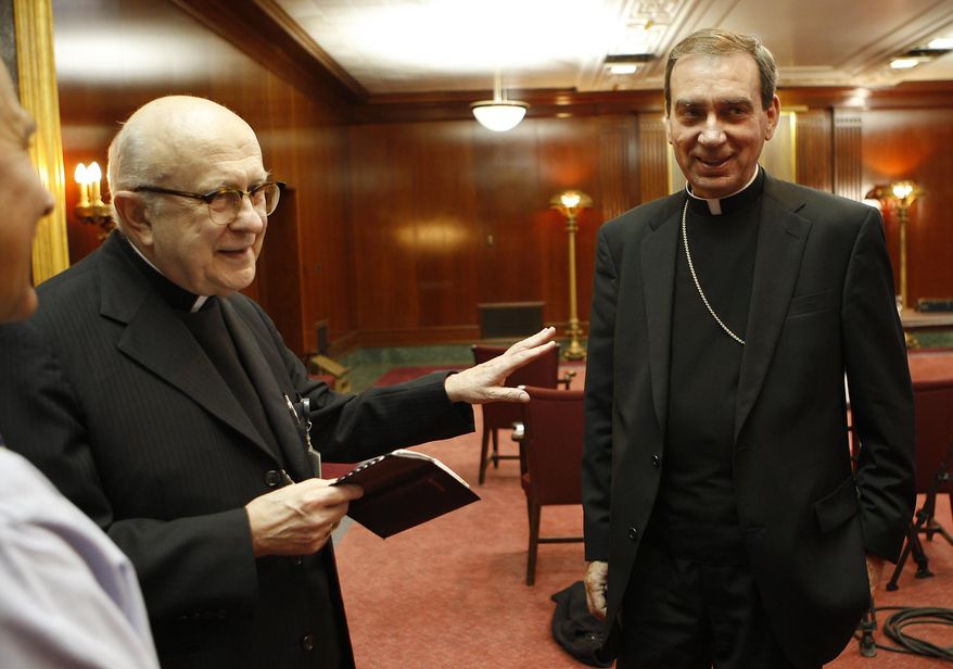 FILE – In this Friday, October 17, 2008 file photo, Pope Benedict XVI has appointed Rev. Dennis M. Schnurr, right the coadjutor archbishop of Cincinnati along with Archbishop Daniel Pilarczyk, left as announced during a press conference. Retired Archbishop Pilarczyk died on Sunday, March 22, 2020. (Jeff Swinger/The Cincinnati Enquirer via AP, File)