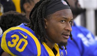 FILE - In this Dec. 29, 2019, file photo, Los Angeles Rams running back Todd Gurley sits on the bench during the second half of an NFL football game against the Arizona Cardinals in Los Angeles. The Atlanta Falcons have agreed to a one-year deal with three-time Pro Bowl running back Todd Gurley, one day after he was cut by the Los Angeles Rams. A person familiar with the deal told The Associated Press about the agreement on Friday, March 20, 2020, on condition of anonymity because the deal will not be official until Gurley passes a physical. (AP Photo/Mark J. Terrill, File)