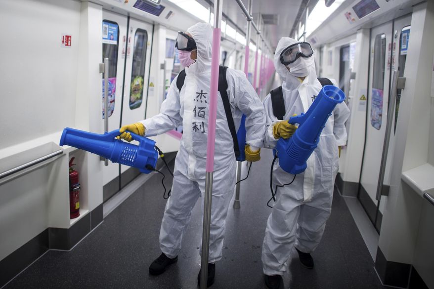 In this March 23, 2020, photo released by Xinhua News Agency, workers disinfect a subway train in preparation for the restoration of public transport in Wuhan, in central China&#x27;s Hubei province. China&#x27;s health ministry says Wuhan has now gone several consecutive days without a new infection, showing the effectiveness of draconian travel restrictions that are slowly being relaxed around the country. (Xiao Yijiu/Xinhua via AP)