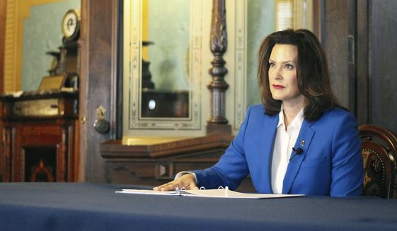 In a pool photo provided by the Michigan Office of the Governor, Gov. Gretchen Whitmer tells Michigan residents to stay at home, in her most sweeping order of the coronavirus crisis, Monday, March 23, 2020 in Lansing, Mich. The governor warned that a million people could need hospital beds if they keep mixing with each other and spreading the illness. Whitmer talked about dire results akin to those seen in Italy if people don't follow her order. (Julia Pickett/Michigan Office of the Governor via AP, Pool)