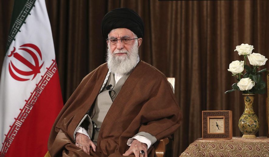 In this picture released by the official website of the office of the Iranian supreme leader, Supreme Leader Ayatollah Ali Khamenei sits prior to address nation on state television, in Tehran, Iran, Sunday, March 22, 2020. Iran's supreme leader Sunday refused U.S. assistance to fight the new coronavirus, citing an unfounded conspiracy theory that the virus could be man-made by America. (Office of the Iranian Supreme Leader via AP)