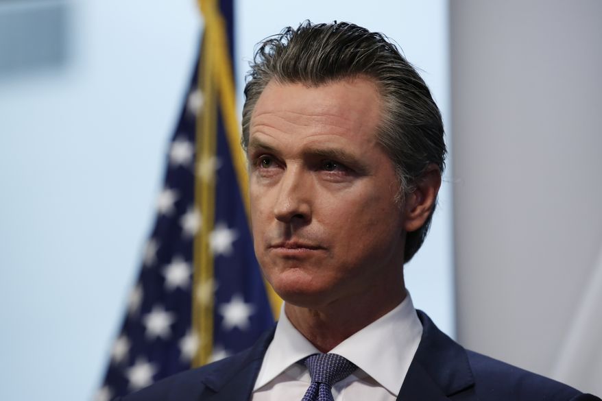 Gov. Gavin Newsom listens to a reporters question during a news conference to update the state's response to the coronavirus at the Governor's Office of Emergency Services in Rancho Cordova, Calif., Monday, March 23, 2020. Newsom announced the closure of all state parking lots to discourage people from congregating at the state beaches and other public spaces during the coronavirus outbreak. (AP Photo/Rich Pedroncelli)