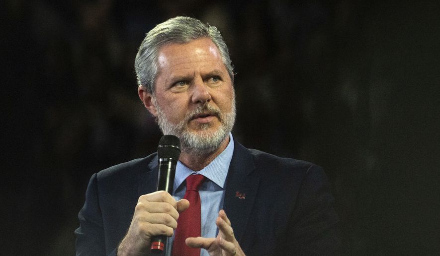 In this, Nov. 13 2019, file photo, Liberty University President Jerry Falwell Jr. talks to Donald Trump Jr. about his new book &quot;Triggered&quot; during convocation at Liberty University in Lynchburg, Va.  (Emily Elconin/The News &amp; Advance via AP)  **FILE**