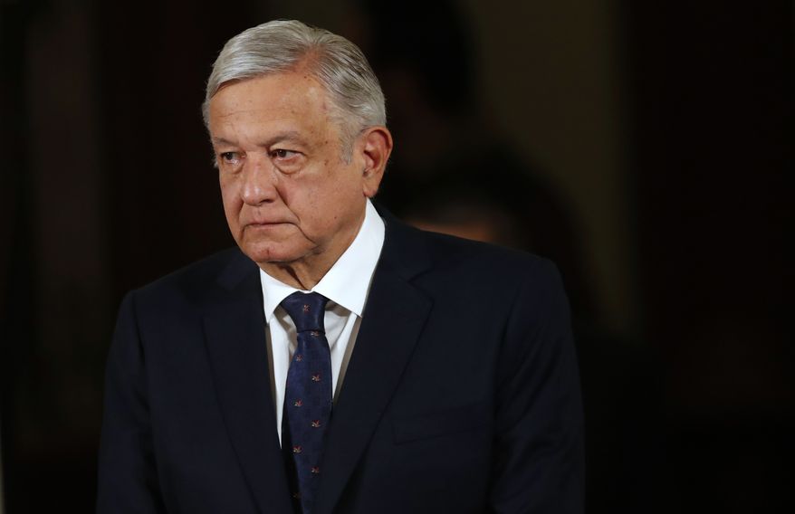Mexico's President Andres Manuel Lopez Obrador arrives for his daily news conference at the presidential palace in Mexico City, Tuesday, March 24, 2020. Lopez Obrador's government is reluctant to implement some of the extreme measures and lockdowns seen in Europe or the United States to help stop the worldwide spread of the new coronavirus. (AP Photo/Marco Ugarte)