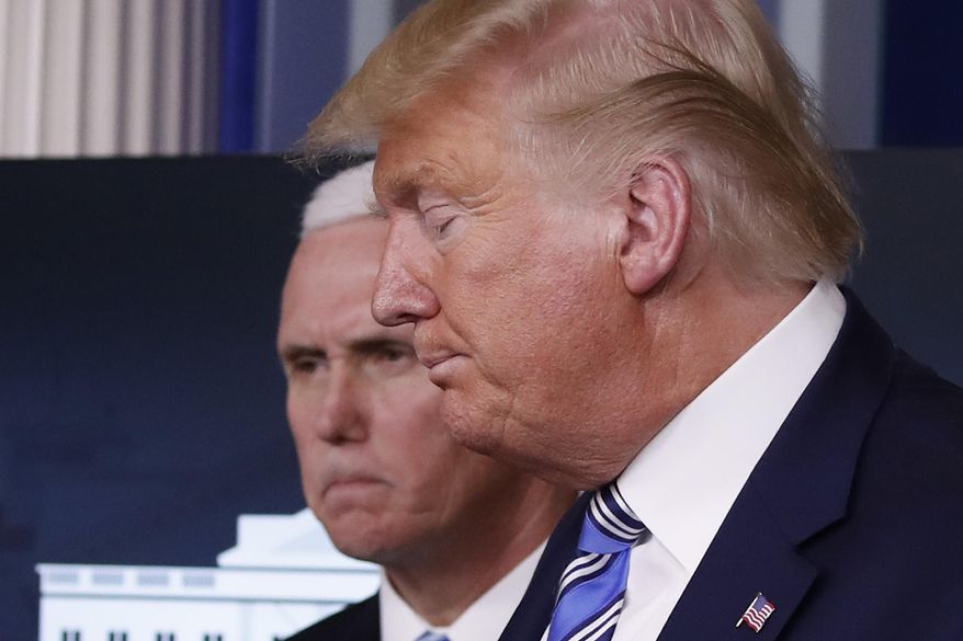 President Donald Trump and Vice President Mike Pence leave at the end of a briefing about the coronavirus in the James Brady Briefing Room, Monday, March 23, 2020, in Washington. (AP Photo/Alex Brandon)
