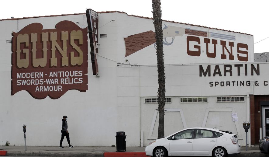 CORRECTS TO CULVER CITY, INSTEAD OF LOS ANGELES Guns are advertised for sale at a gun shop Tuesday, March 24, 2020, in Culver City, Calif. Los Angeles County Sheriff Alex Villanueva said he would like to see gun shops shut down. "We will be closing them, they are not an essential function," Villanueva said. Adding guns to households where more people are at home during a crisis increases the risk that someone will be shot, he said. (AP Photo/Marcio Jose Sanchez)
