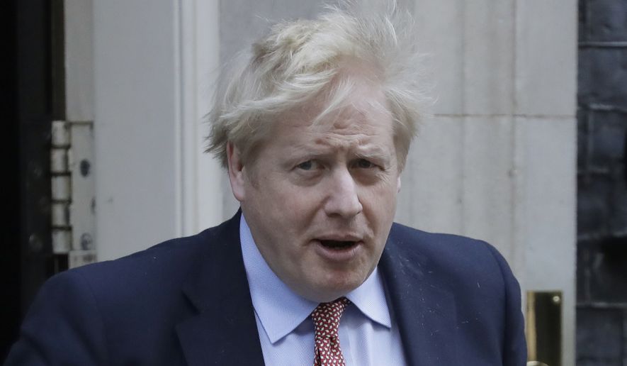 Britain&#39;s Prime Minister Boris Johnson leaves 10 Downing Street for the House of Commons for his weekly Prime Ministers Questions, in London, Wednesday, March 25, 2020. (AP Photo/Matt Dunham)