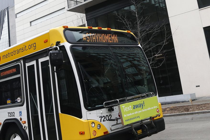 A Metrotransit bus uses the marquee to advise Minnesotans to stay home as it travels on the Nicollet Mall Wednesday, March 25, 2020, in Minneapolis, an effort to slow down the coronavirus in the state. The new coronavirus causes mild or moderate symptoms for most people, but for some, especially older adults and people with existing health problems, it can cause more severe illness or death. (AP Photo/Jim Mone)