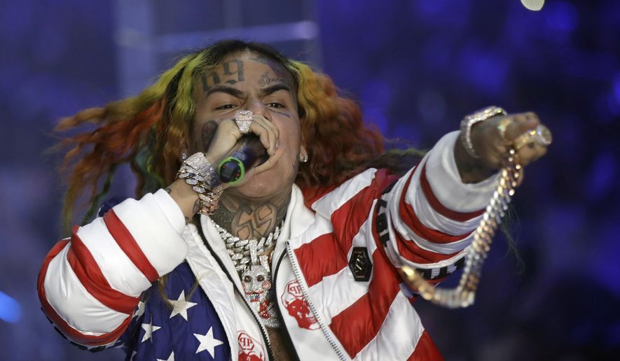FILE- In this Sept. 21, 2018, file photo rapper Daniel Hernandez, known as Tekashi 6ix9ine, performs during the Philipp Plein women's 2019 Spring-Summer collection during the Fashion Week in Milan, Italy. U.S. District Judge Paul A. Engelmayer, who sentenced the rapper to prison said Wednesday, March 25, 2020, that he would have ordered home confinement instead, he had known about the coronavirus in December. (AP Photo/Luca Bruno, File)