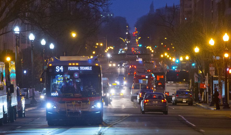 A Metro bus makes its way down 16th Street in downtown Washington. (AP Photo/Pablo Martinez Monsivais) **FILE**