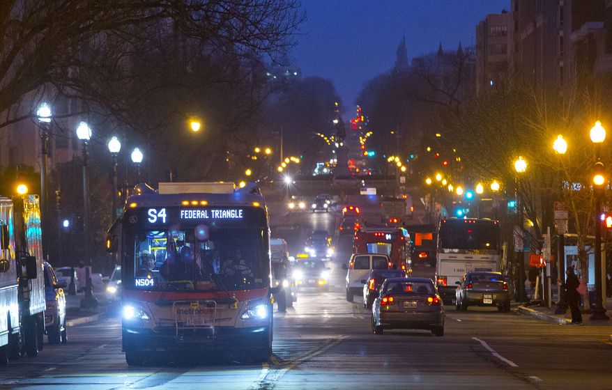 Metro bus makes it way down 16th street in in downtown Washington. (AP Photo/Pablo Martinez Monsivais)