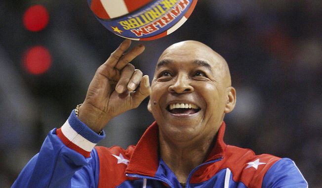 The Harlem Globetrotters&#x27; Fred &quot;Curly&quot; Neal performs during a timeout in the second quarter in an NBA basketball game between the Indiana Pacers and the Phoenix Suns in Phoenix. Neal, the dribbling wizard who entertained millions with the Harlem Globetrotters for parts of three decades, has died the Globetrotters announced Thursday, March 26, 2020. He was 77. Neal played for the Globetrotters from 1963-85, appearing in more than 6,000 games in 97 countries for the exhibition team known for its combination of comedy and athleticism. (AP Photo/Ross D. Franklin, File)  **FILE**