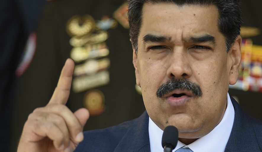 In this March 12, 2020, file photo, Venezuelan President Nicolas Maduro speaks at a press conference at the Miraflores Presidential Palace in Caracas, Venezuela. The Trump administration will announce Thursday, March 26, 2020, indictments against Maduro and members of his inner circle for effectively converting Venezuela&#39;s state into a criminal enterprise at the service of drug traffickers and terrorist groups, according to multiple people familiar with the situation. (AP Photo/Matias Delacroix, File) **FILE**
